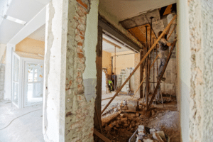 Home renovation in progress with exposed walls and construction debris