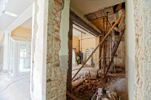 Home renovation in progress with exposed walls and construction debris