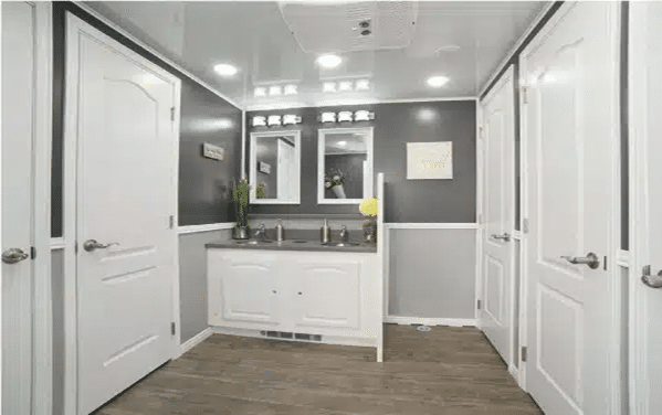 Spacious luxury restroom trailer interior with sinks and private stalls
