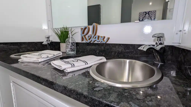 Luxury restroom trailer interior with modern sink and countertops